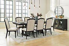 a dining room table and chairs with white upholstered chairs in front of large windows