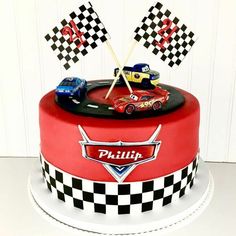 a birthday cake with cars on top and checkered flags