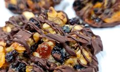 chocolate covered cookies with nuts and raisins on top