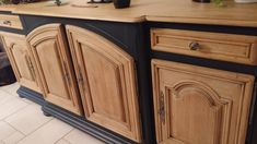 a kitchen island made out of wood and black paint