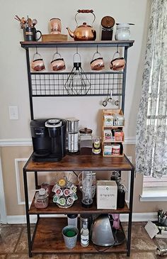 a shelf filled with lots of different types of coffee pots and pans on top of it