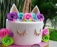 a cake decorated with flowers and cat ears