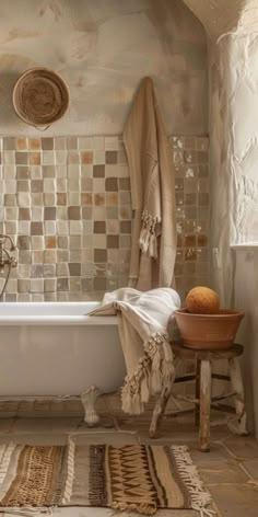 a bathroom with a bathtub, rugs and baskets on the floor in front of it