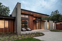 a modern house with wood siding and glass windows