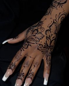 a woman's hand with black and white designs on it