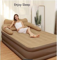 a woman laying on an inflatable bed that is made to look like a giant mattress