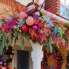 a decorated front porch with wreaths and decorations