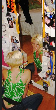 two women sitting on the floor in front of a mirror looking at their selfs