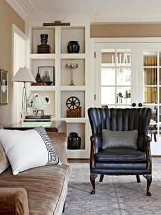 a living room filled with furniture and bookshelves