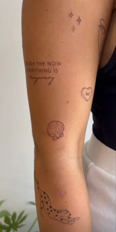 a woman's arm with tattoos on it that says, enjoy the now everything is