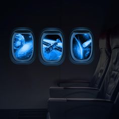 an airplane seat with two windows showing the view of space