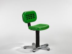 a green office chair sitting on top of a metal base with four screws in front of it