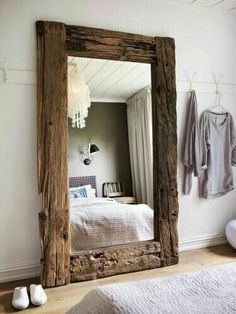 a bedroom with a large mirror on the wall