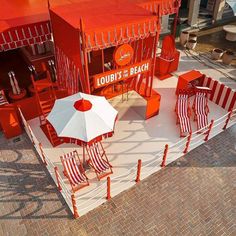 red and white striped beach chairs with umbrellas