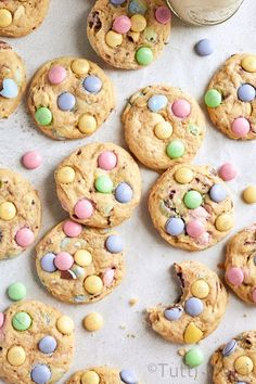 chocolate chip cookies with m & m's and easter eggs on top, scattered around