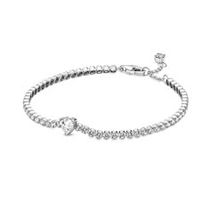 Bring elegance to your outfit with the Sparkling Pavé Tennis Bracelet. Hand-finished in sterling silver, this tennis bracelet is decorated with sparkling clear cubic zirconia. A large central heart-shaped stone punctuates a row of evenly sized pavé. The bracelet includes a lobster clasp for safe closure and can be adjusted to three lengths. Style it with other shimmering Pandora Timeless pieces for a classic look that stands out. Pandora Heart Tennis Bracelet, Tenis Bracelet Pandora, Pandora Diamond Bracelet, Pandora Tennis Bracelet, Pandora Heart Bracelet, Pandora Heart, Sparkle Bracelet, Expensive Jewelry Luxury, Luxe Jewelry