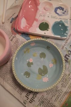 a bowl and plate sitting on top of a newspaper