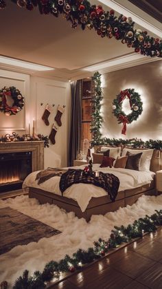 a bedroom decorated for christmas with wreaths and lights on the fireplace mantel area