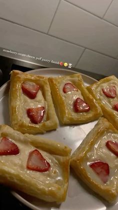 small pastries with strawberries are on a plate