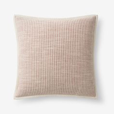 a beige and white pillow on a white background