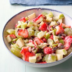 a white bowl filled with fruit salad on top of a table