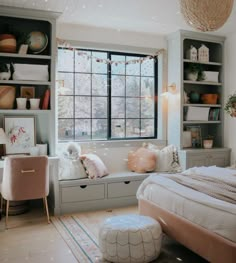 a bedroom with a bed, window seat and shelves filled with items on the wall