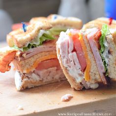 a cut in half sandwich sitting on top of a cutting board