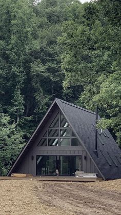 a - frame cabin nestled in the woods surrounded by trees