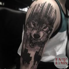 a man with a wolf tattoo on his arm