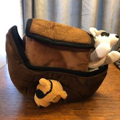 a stuffed animal in a brown bag on a table