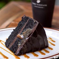 a piece of chocolate cake sitting on top of a white plate