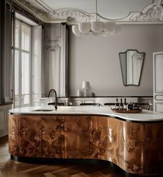 an elegant kitchen with marble counter tops and wooden floors