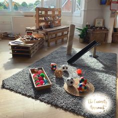 a living room filled with lots of furniture and decor on top of a gray rug