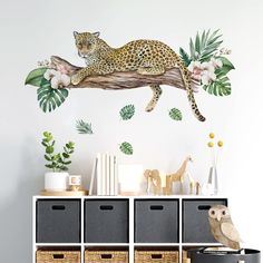 a wall decal with a leopard on a tree branch and flowers in the background