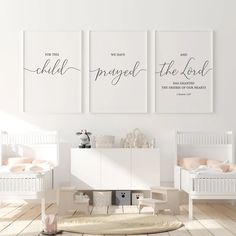 two white cribs with posters on the wall above them in a baby's room