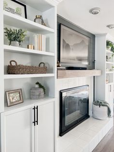 a living room filled with furniture and a fire place in front of a tv mounted on a wall