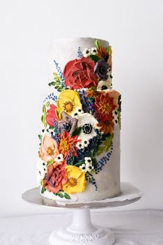 a white cake with colorful flowers on it