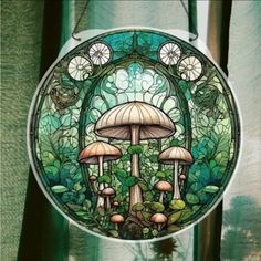 there is a stained glass window with mushrooms in the center and green foliage around it