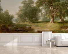 a living room with a white couch and wall mural depicting a wooded scene on the walls