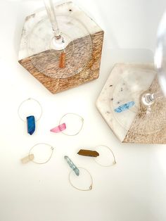 several different types of jewelry sitting on top of a white table next to each other