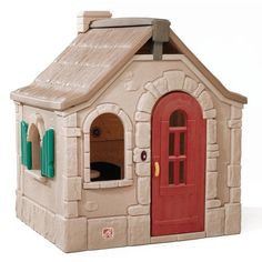 a toy house with a red door and green shutters