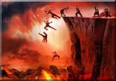 a group of people standing on top of a cliff with fire in the sky behind them