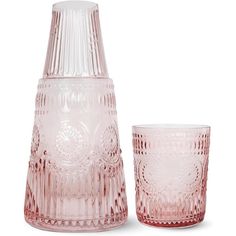 two pink glass vases sitting next to each other