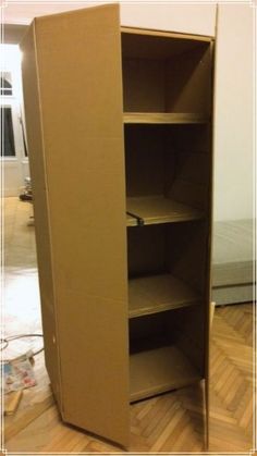 an open cardboard box sitting on top of a hard wood floor