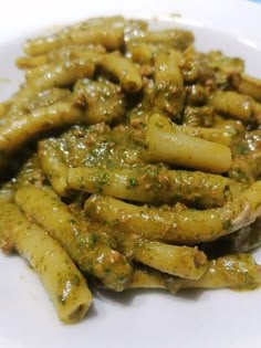 some green beans are on a white plate and is ready to be eaten by someone