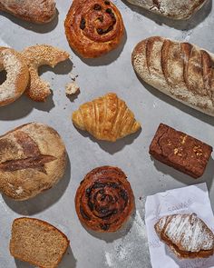 many different types of breads and pastries on a table