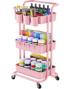 a pink cart filled with lots of paint and art supplies on top of each other