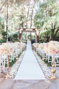 an outdoor ceremony with white and pink flowers