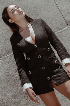 An ultra-chic design in a cozy, textured fabric — a match made in heaven! Crafted from a knit blend in midnight black, the Odette blazer dress features a deep V collarless neckline, button-down front, structured shoulders and a mini-dress length. Contrasting mock sleeves peek out from underneath for a polished, layered look, while the dress is finished with four patch pockets and gemstone accents. #blazerdress #blazer #blazeroutfitsforwomen #blackblazer Chic V-neck Party Blazer, Chic V-neck Outerwear For Night Out, Chic V-neck Cardigan For Office, V-neck Winter Evening Outerwear, Chic V-neck Cardigan For Formal Occasions, V-neck Blazer Dress With Buttons For Work, Winter V-neck Blazer With Buttons, Chic V-neck Winter Blazer, Elegant V-neck Outerwear With Hidden Button Closure