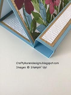 a close up of a card with flowers and leaves on it's front side